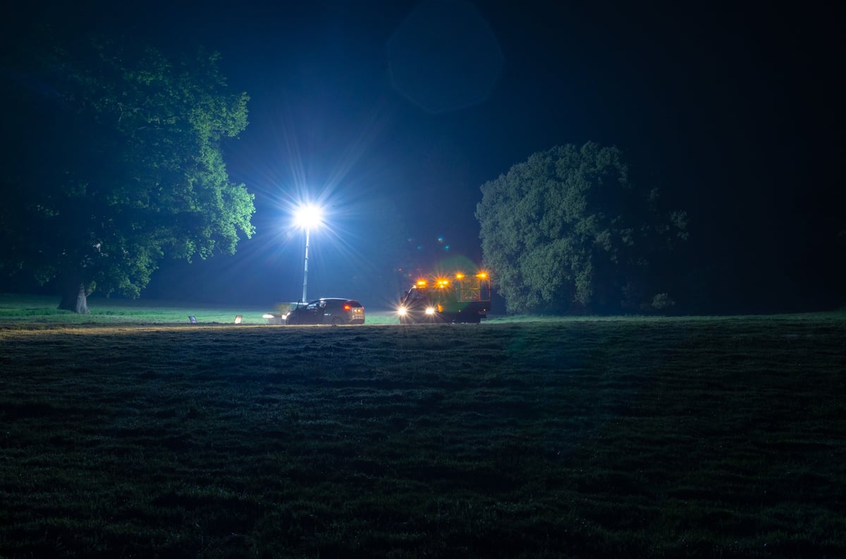 Emergency recovery truck assisting a broken down vehicle at night